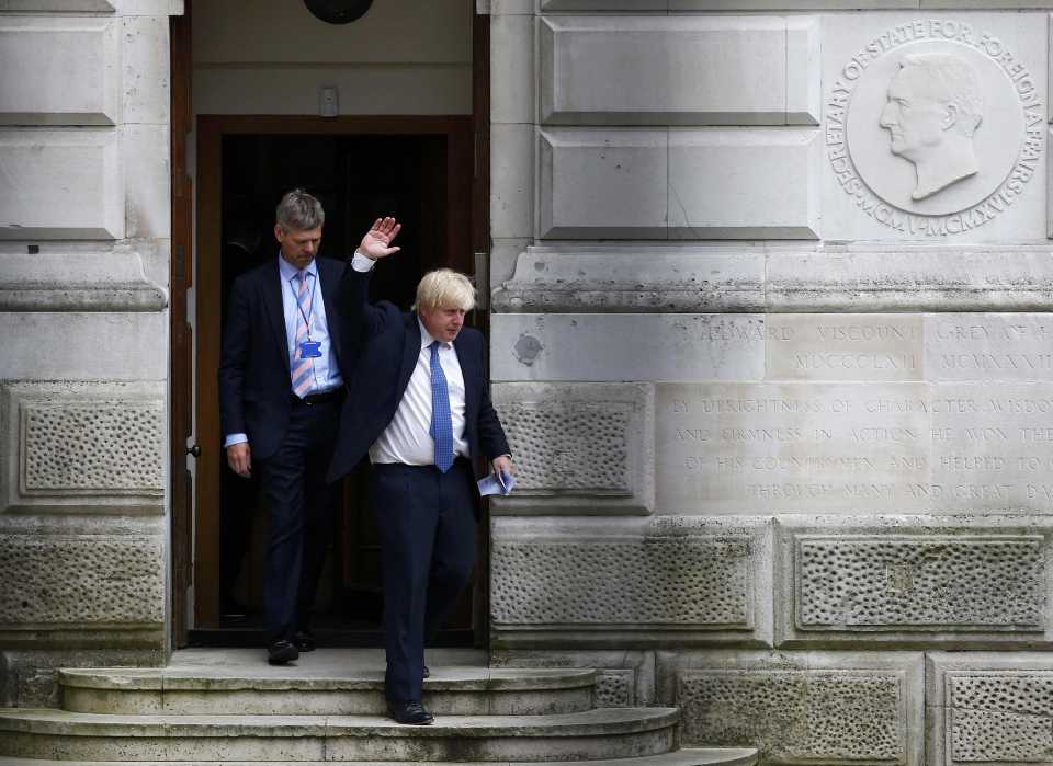 Britain's Foreign Secretary Boris Johnson waves as he leaves the Foreign Office in central London