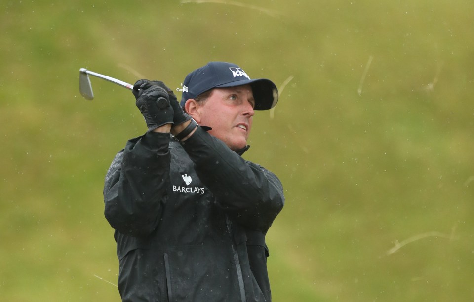 Phil Mickelson has a swing in the rain of Royal Troon