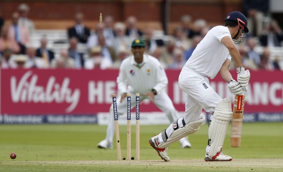 Alastair Cook watches on as he plays on to a ball from Mohammad Amir