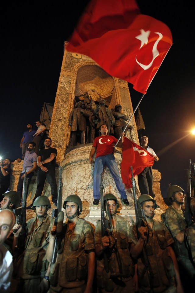  Surrounded by soldiers supporters of President Erdogan protest in Istanbul's Taksim square after he called on them to show their opposition to the coup