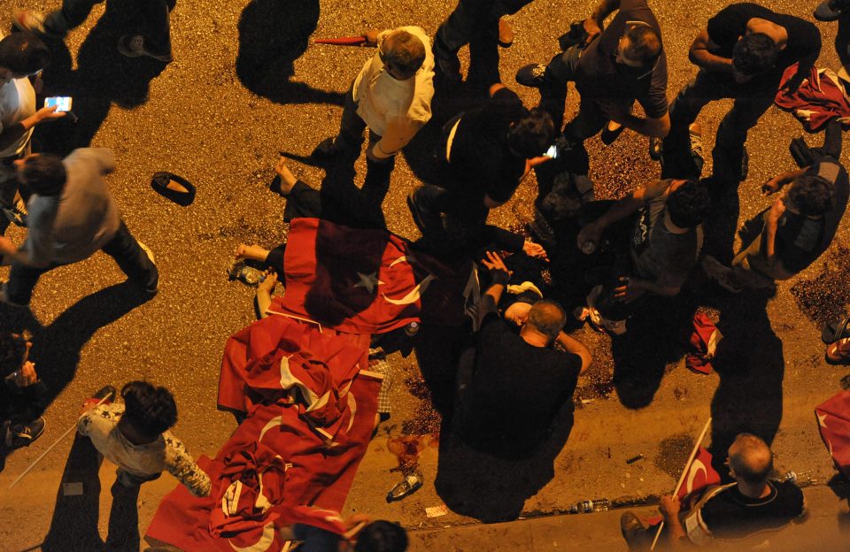 The Turkish flag is trampled with hundreds of people injured in the clashes between military and government supporters