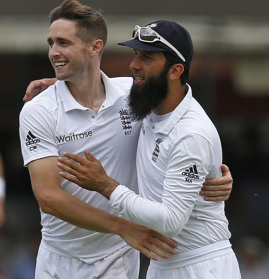 Chris Woakes celebrates with team-mate Moeen Ali after dismissing Shan Masood