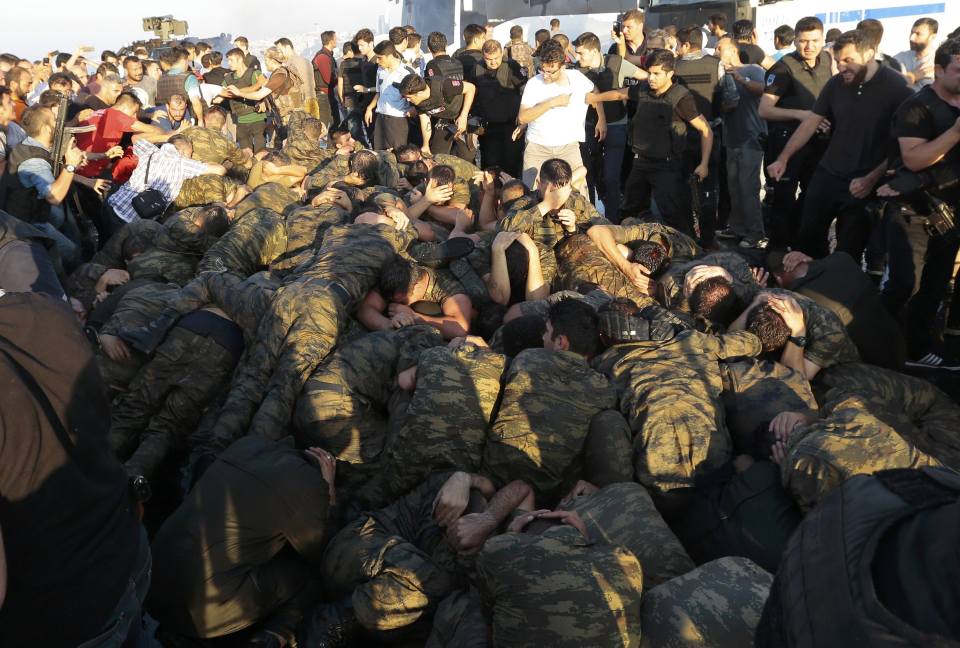 Surrendered Turkish soldiers who were involved in the coup cower from crowds