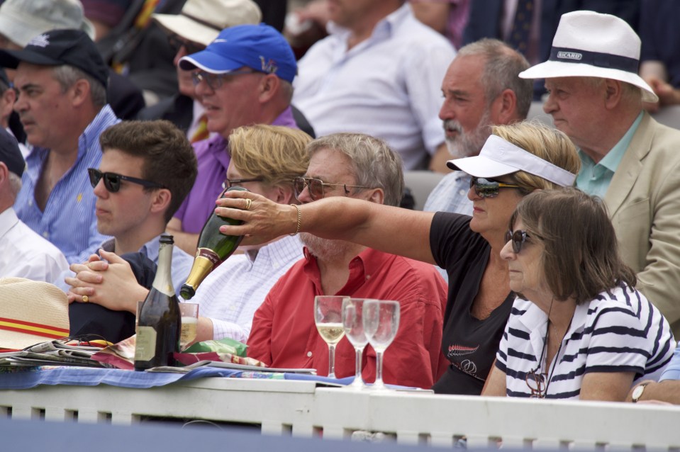  A spectator gets the last drop out of the bottle during the Investec Test Match match at Lord's