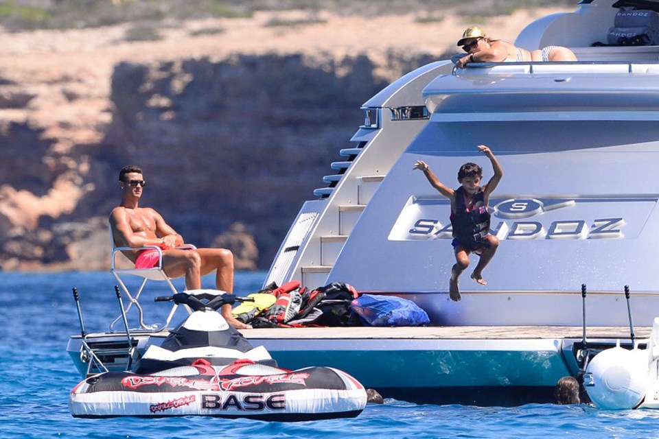  Call that a dive? ... Proud dad Ronaldo sits back as son Cris prepares to make a big splash