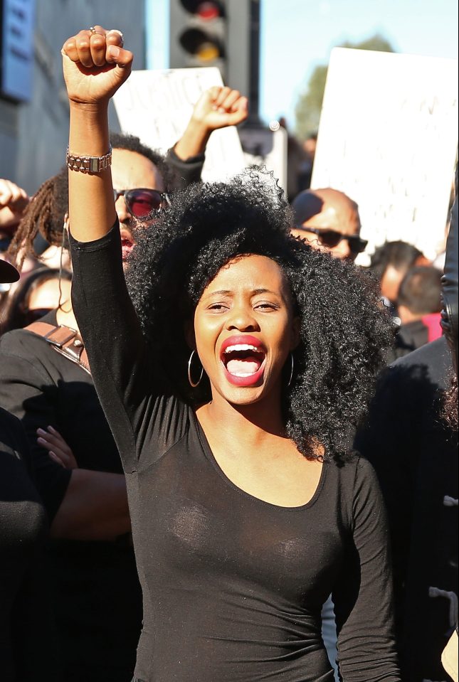 People dressed in black clothes rally to support the Black Lives Matter movement in Melbourne