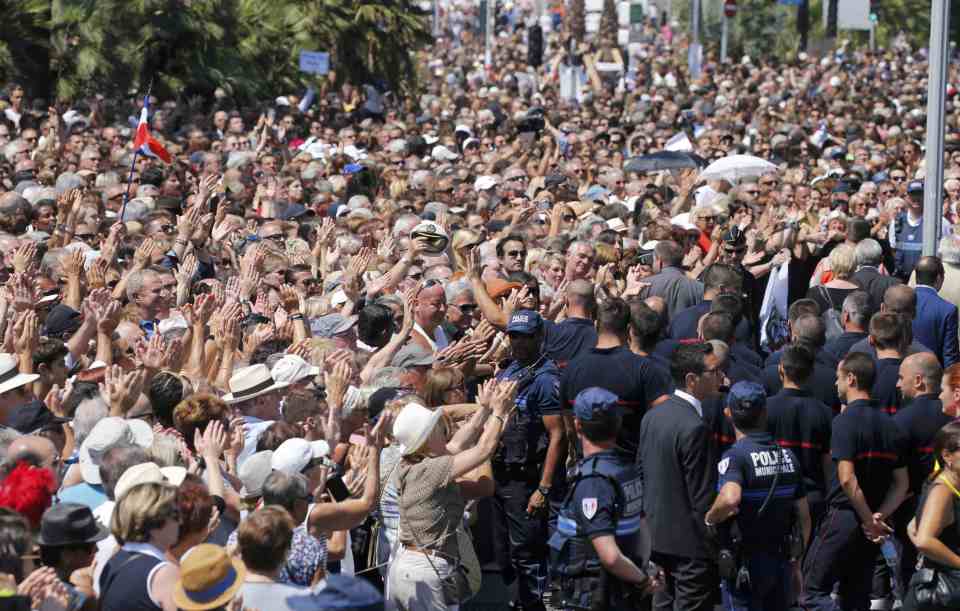 Cheers... People applaud French police and rescue teams after the minute's silence at the Monument du Centenaire on the third day of national mourning to pay tribute to victims of the truck attack