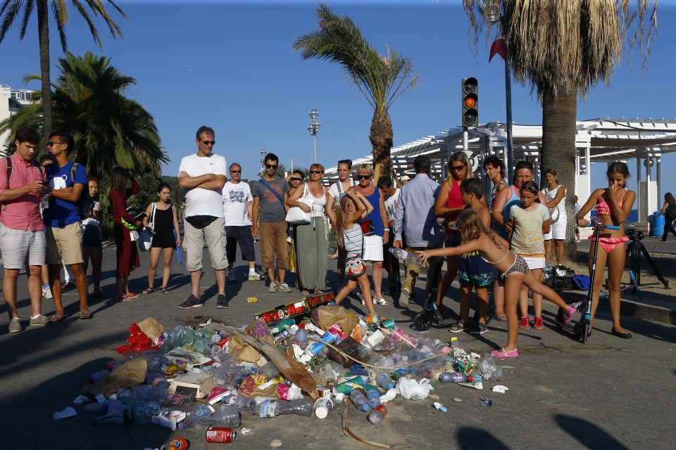  Child throws an empty bottle onto the Shrine of Shame marking where the killer was shot down