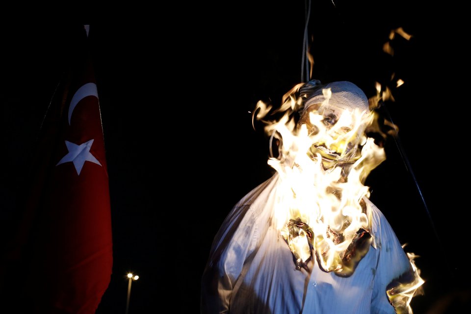 Supporters of Turkish President Tayyip Erdogan burn an effigy of U.S.-based cleric Fethullah Gulen hanged by a noose during a pro-government demonstration on Taksim Square in Istanbul