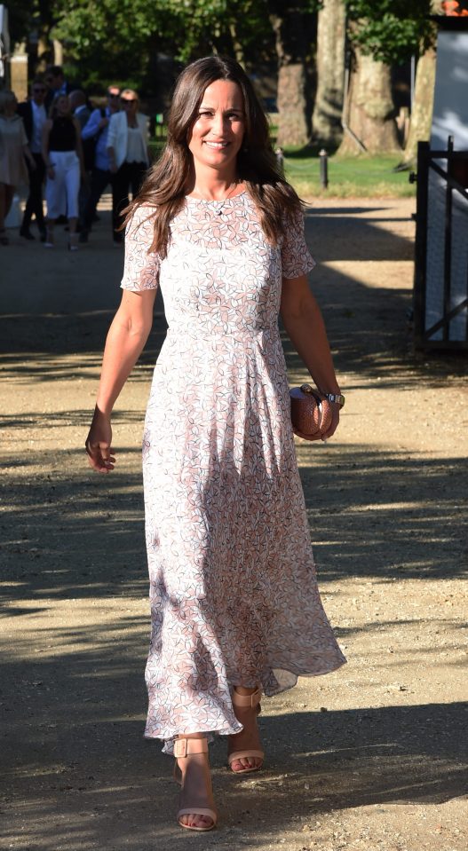 A beaming Pippa arrives for the Frost family summer party in London last night