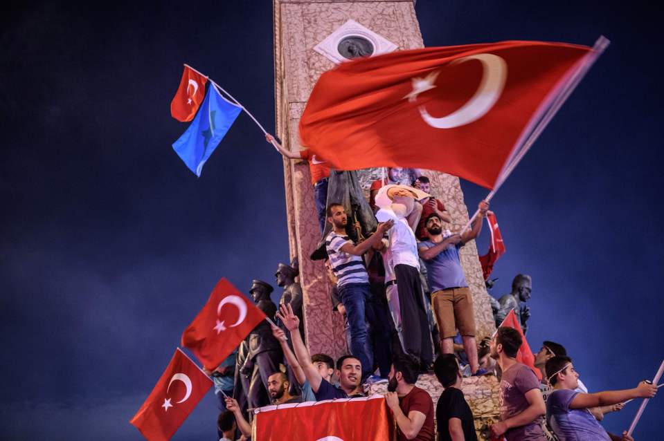 TOPSHOT - Pro-Erdogan supporters hold an