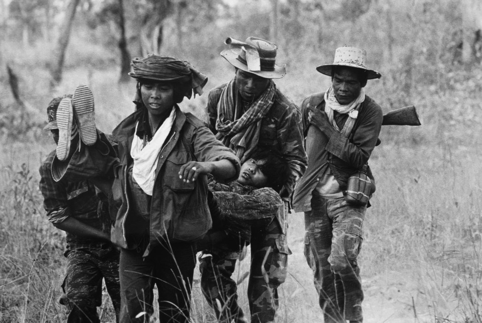 A soldier from one of the guerilla group is evacuated after