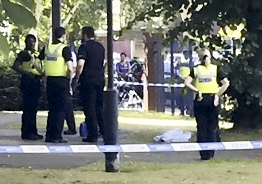 Police cordon off the scene as the baby girl's body is covered following the tragedy