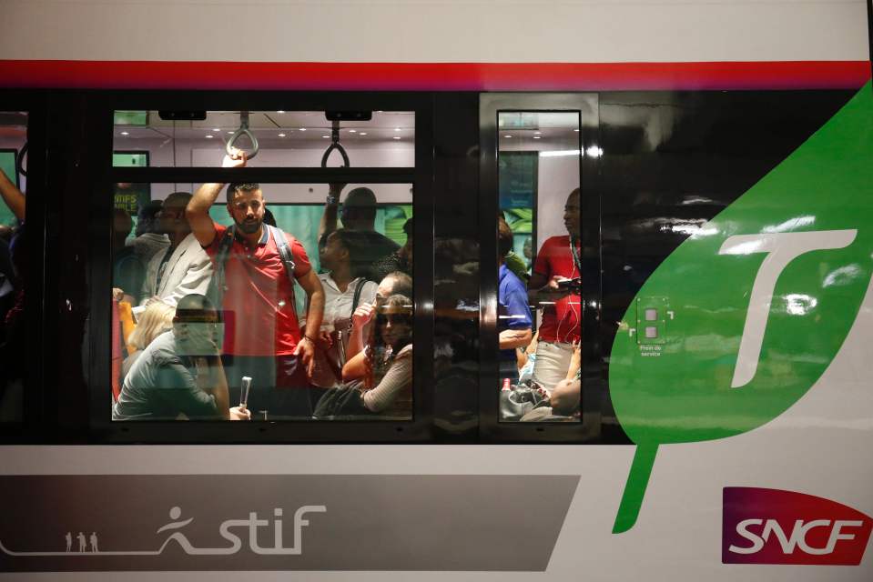 People sit in a train at the Gare du Nor