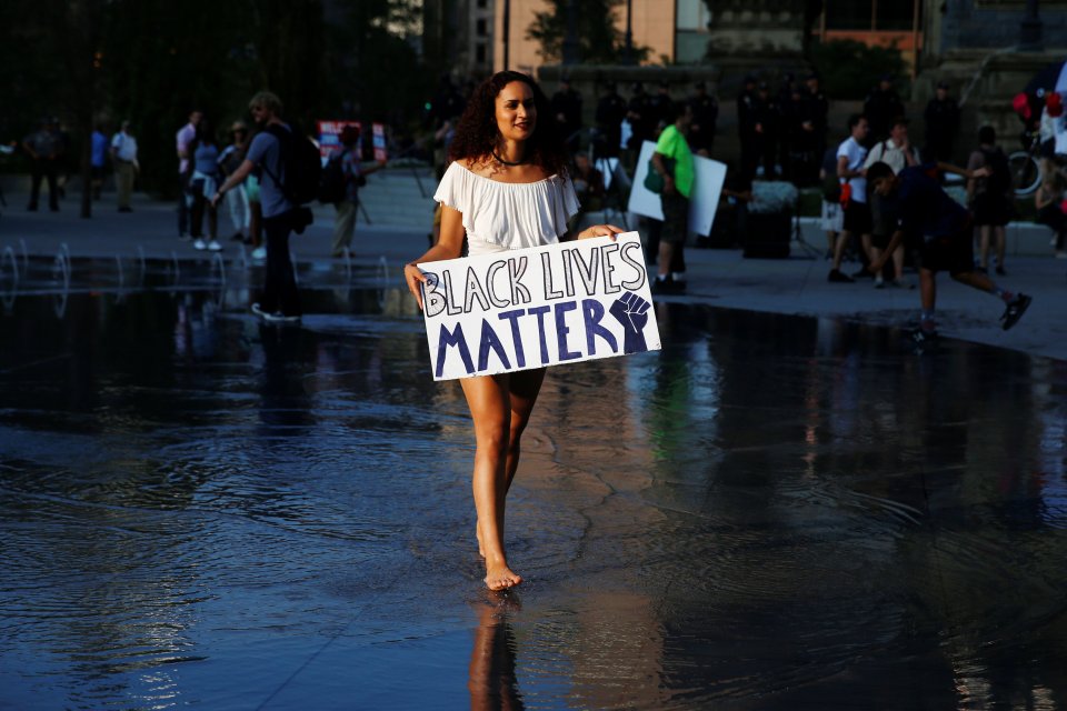 Nyima Coleman holds a Black Lives Matter sign at Public Square outside the Republican National Convention in Cleveland, Ohio - just one of the many protesters involved in the protests across the US