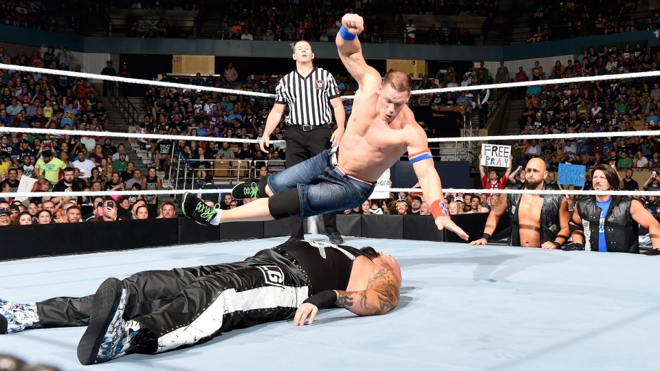 John Cena hist a five-knuckle shuffle on Luke Gallows