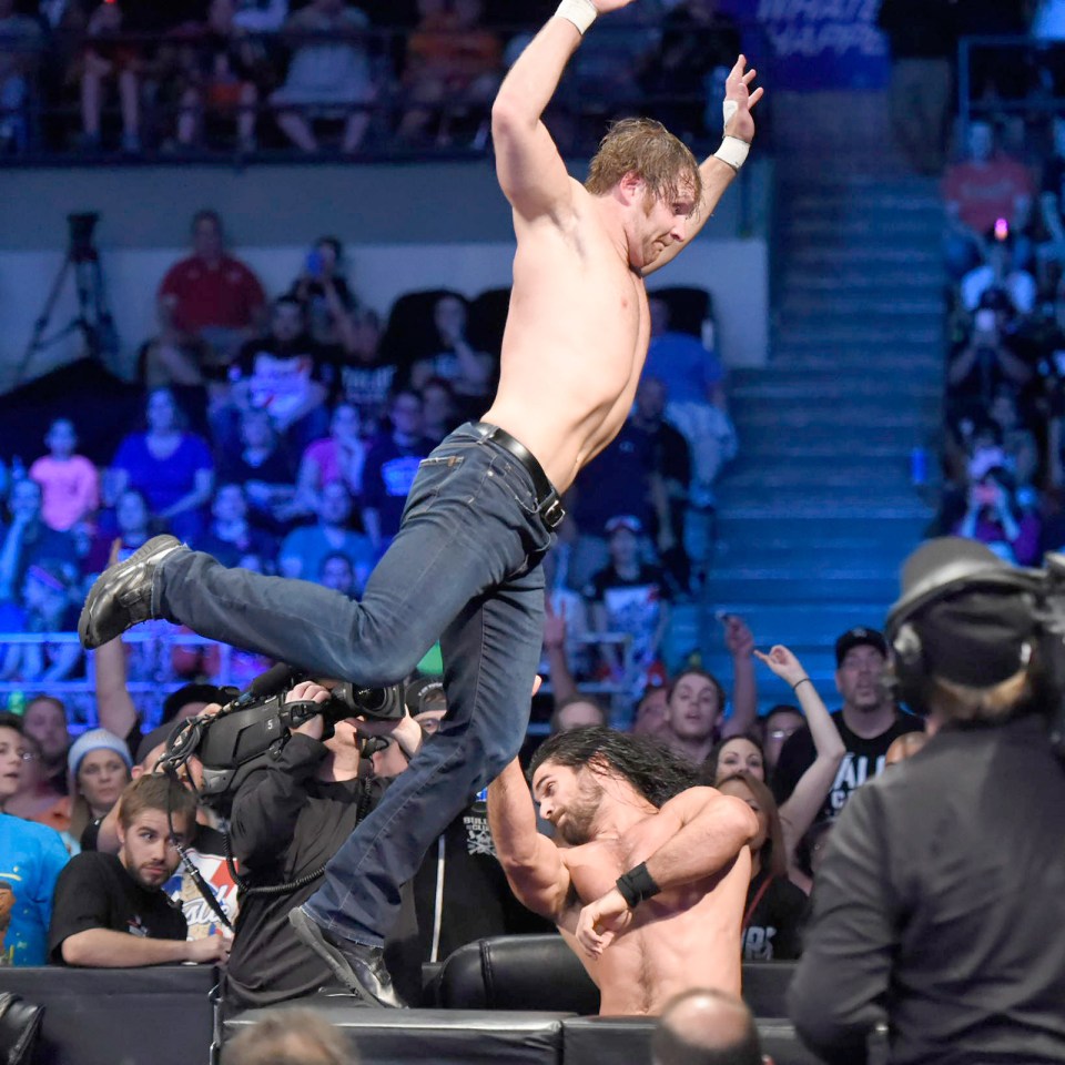 Dean Ambrose leaps from the outside on Seth Rollins