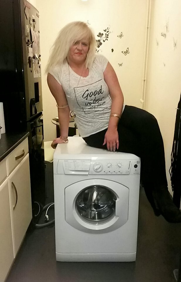 Posing up on a washing machine after being outed as a conwoman