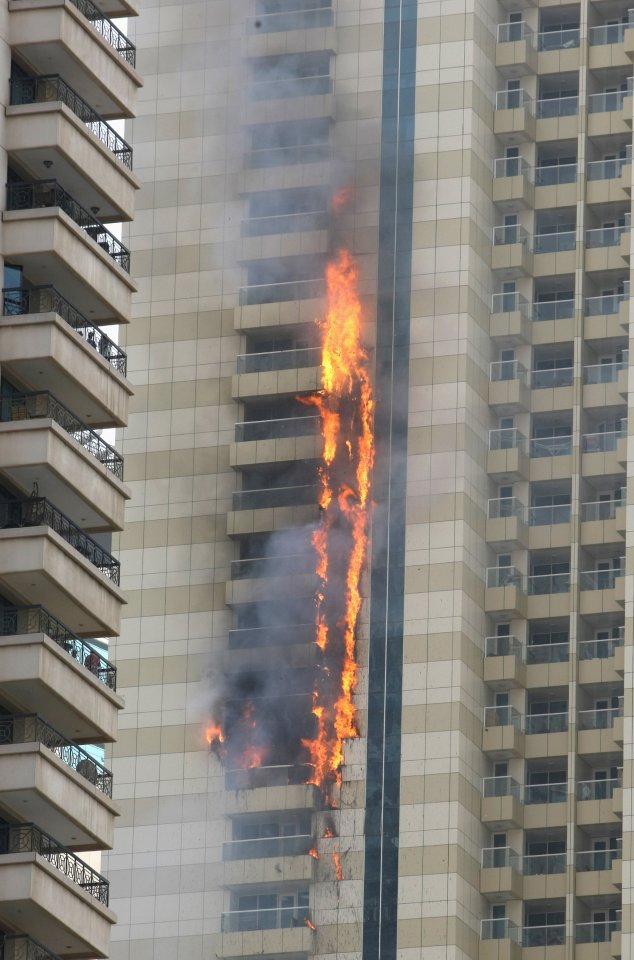 Flames licked the side of the skyscraper, working their way up and down the 75-storey structure