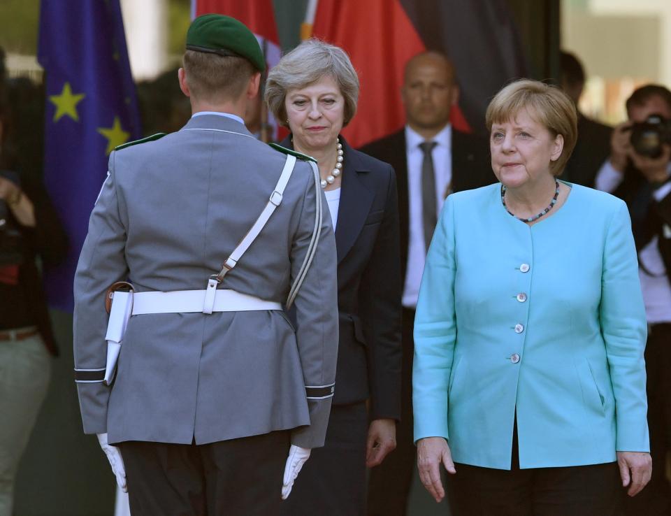  German Chancellor Angela Merkel receives the new Prime Minister Theresa May with military honours at the Chancellery in Berlin