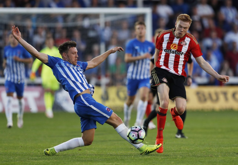 Sunderland starDuncan Watmore tussles for the ball in a contest overshadowed by off-field events