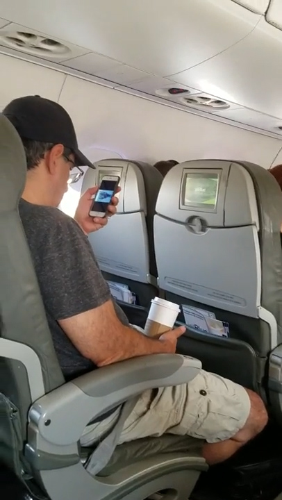  The passenger was shocked to see the man watching footage of the deadly terror attack on his phone