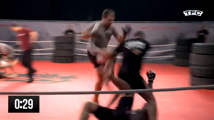  One brawler launches a flying knee to his rival's head