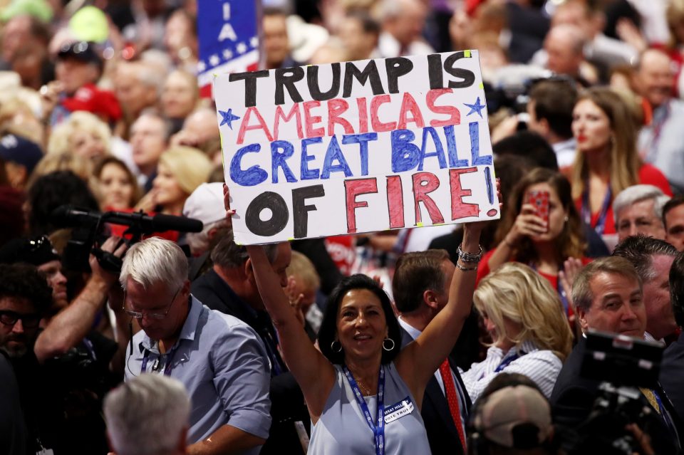  A delegate holds up a sign that reads "Trump is Americas Great Ball of Fire" during the fourth day of the Republican National Convention