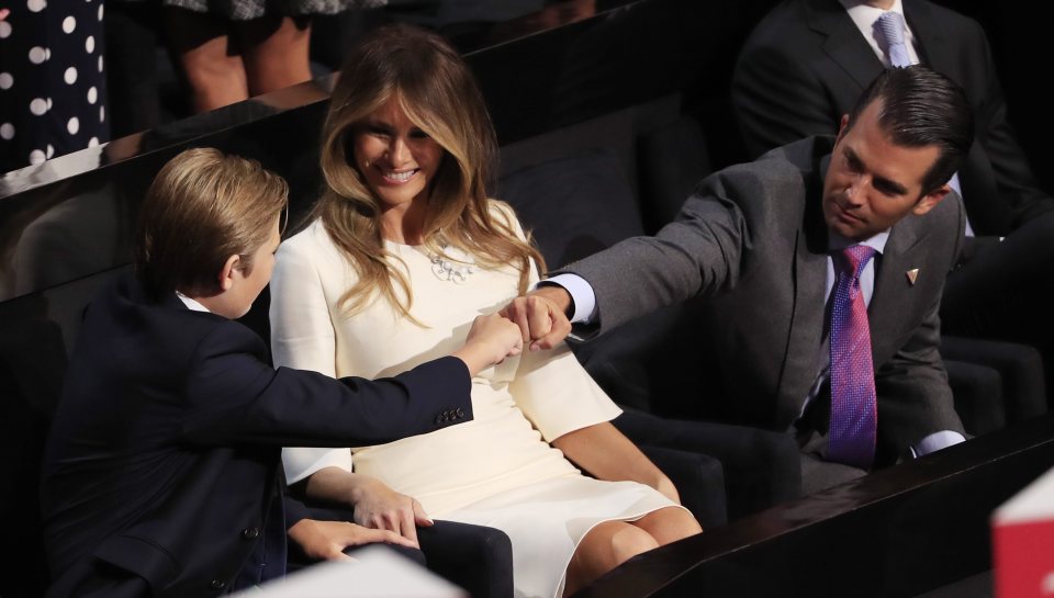  Donald Trump Jr (right) and Barron Trump (left) bump fists in front of Melania Trump during the final day of the 2016 Republican National Convention