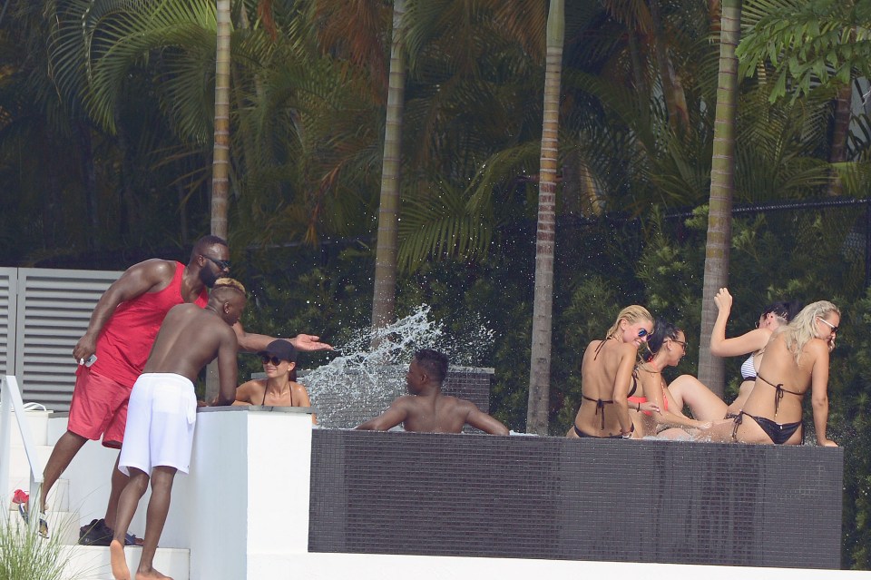 Pogba's pals party by the pool at the mansion while he speaks with Raiola