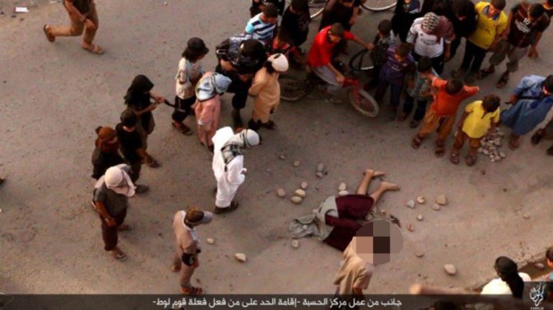 ISIS thugs stone a gay man's body even though he is already dead