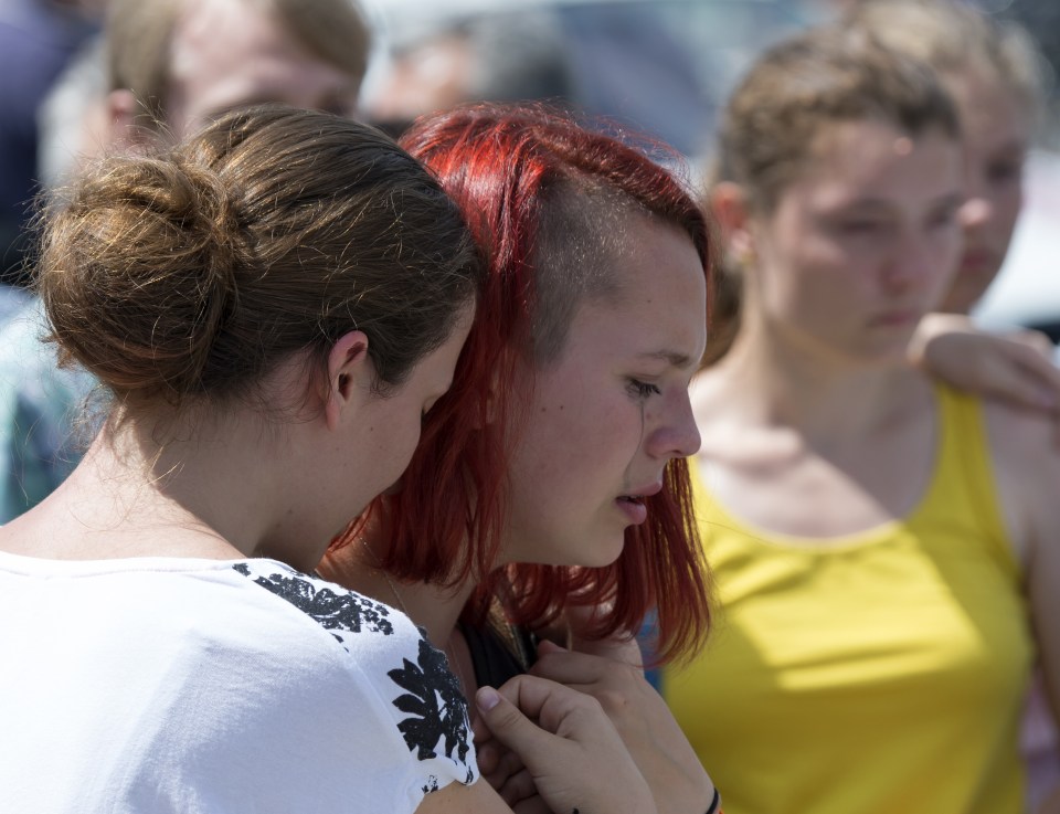  Young women paid their respects outside the Olympia shopping mall today as the country continued to mourn two days after the massacre