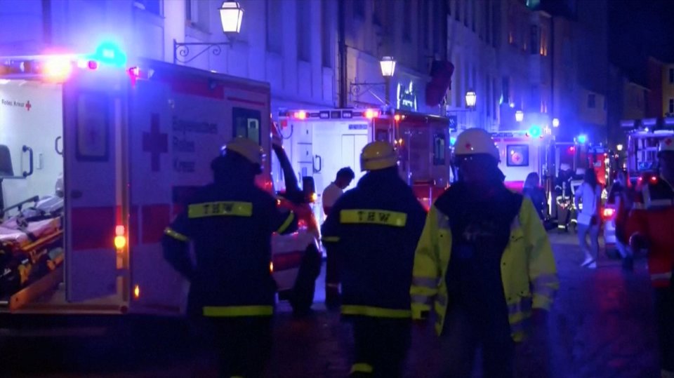 Emergency workers and vehicles are seen following an explosion in Ansbach