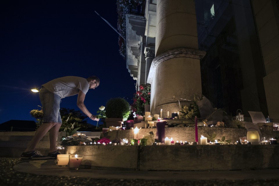 Members of the public lit candles and left flowers in front of the city hall