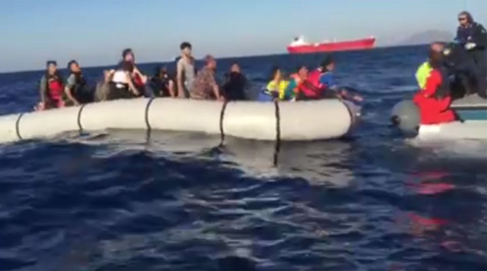 The child is pulled to safety, narrowly avoiding falling into the sea