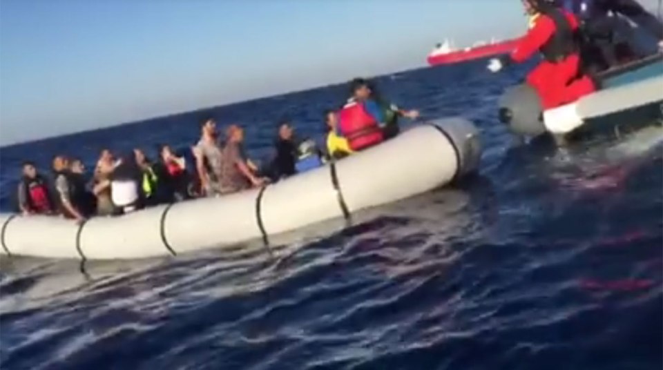 The baby's parents prepare to pass the baby over to rescuers