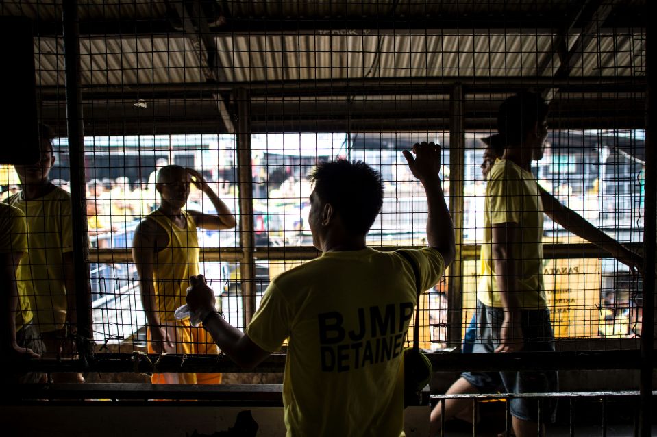  Inmate Mario Dimaculangan looks at other detainees inside the Quezon City Jail