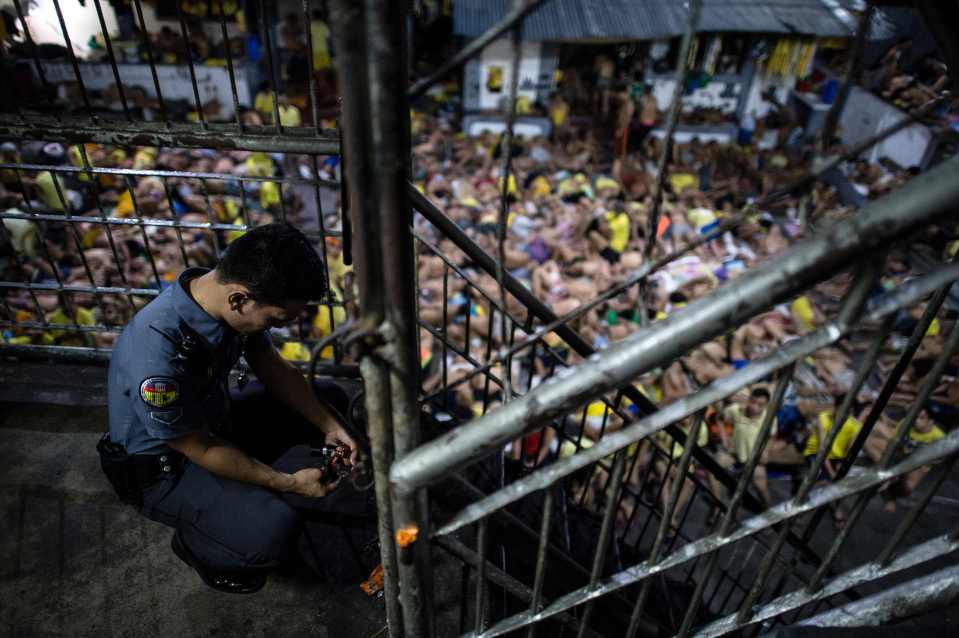  A prison guard locks a gate inside the squalid lock up