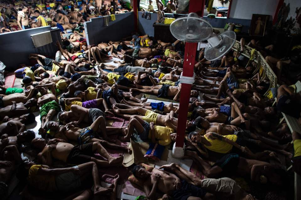  Inmates sleep on the ground inside the Quezon City jail in Manilla