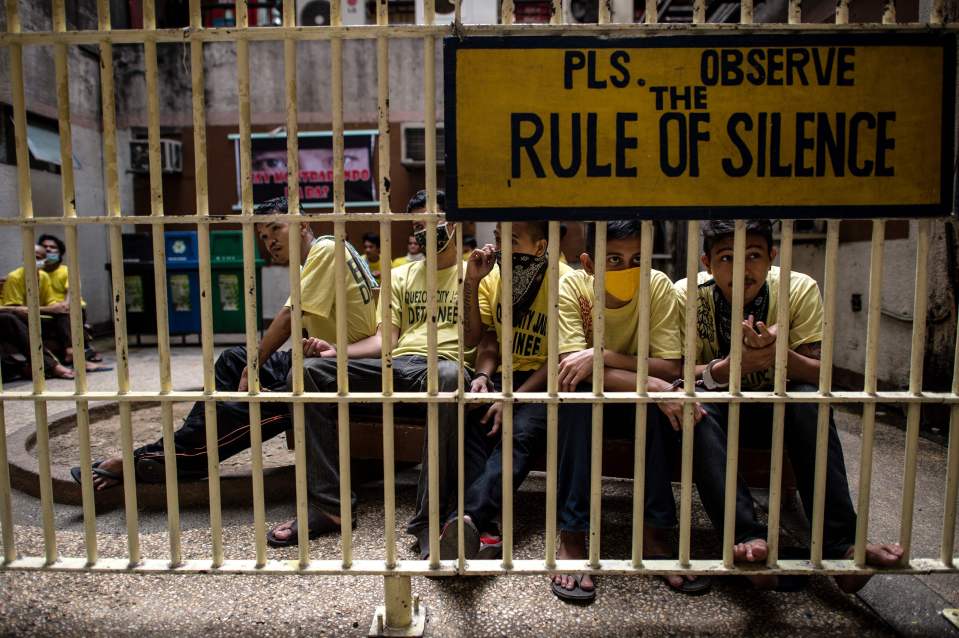  Inmates wait at the holding area ahead of their day in court