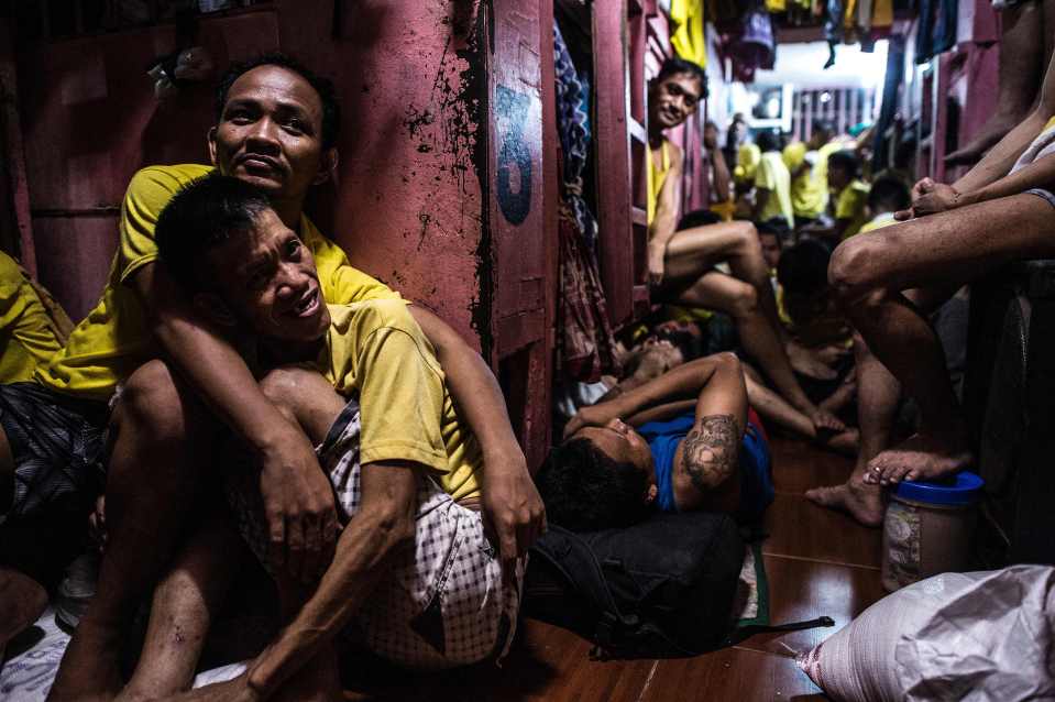  Inmates rest in their sleeping quarters inside the prison