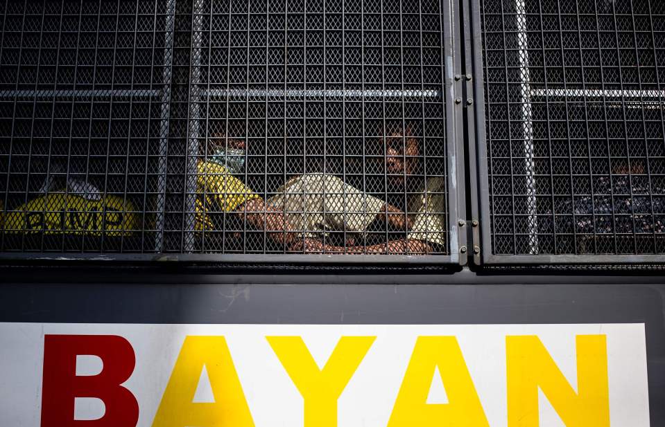  Inmates ride on a prison bus to attend their trial