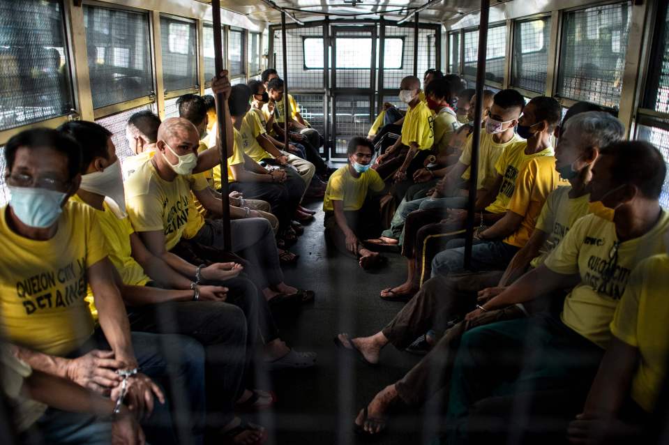  Inmates ride on a prison bus to attend their trial