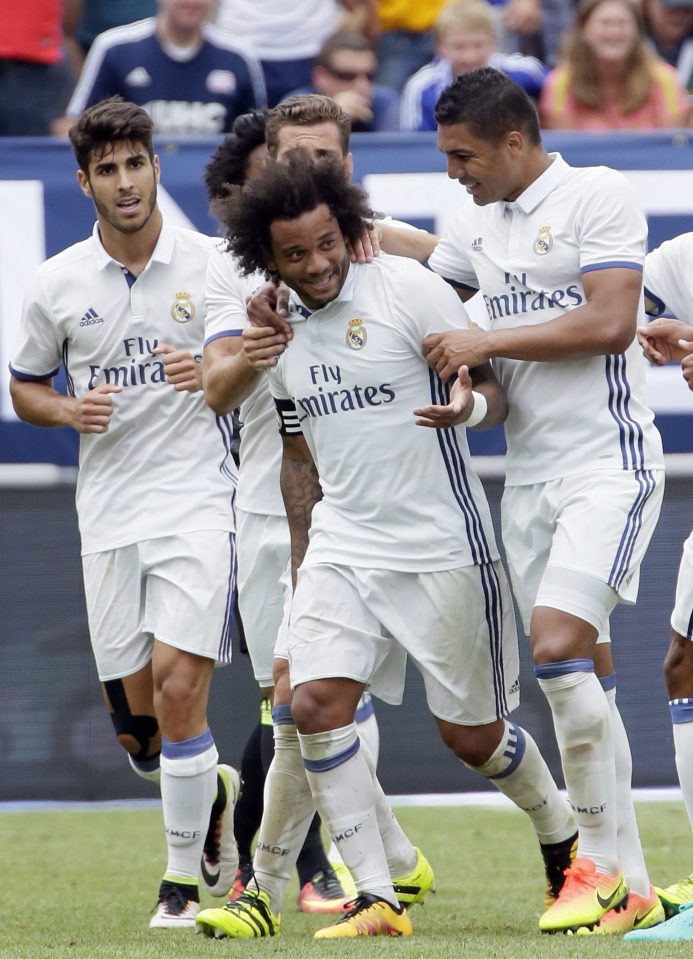 Marcelo is congratulated by his teammates after netting in Michigan 