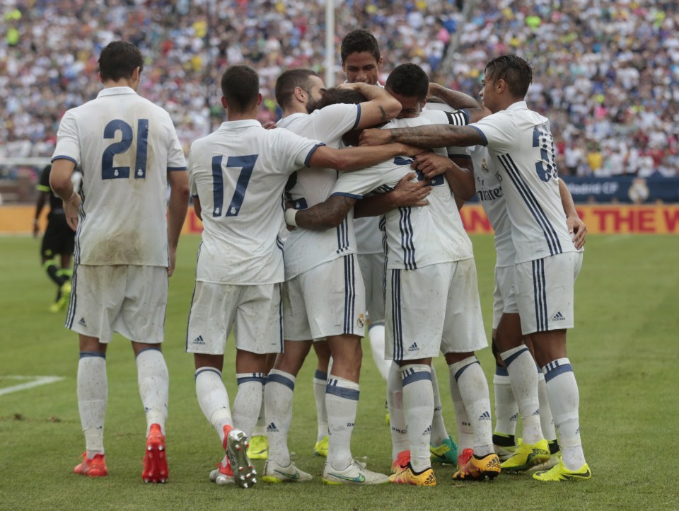 Real's players celebrate in a first half blitz of Antonio Conte's Chelsea