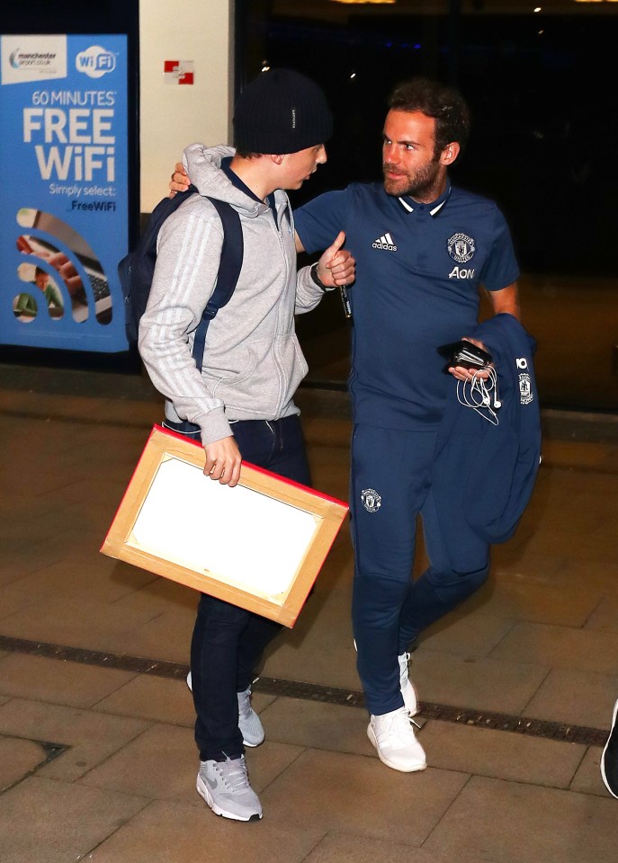  Juan Mata was snapped chatting to a fan at Manchester airport