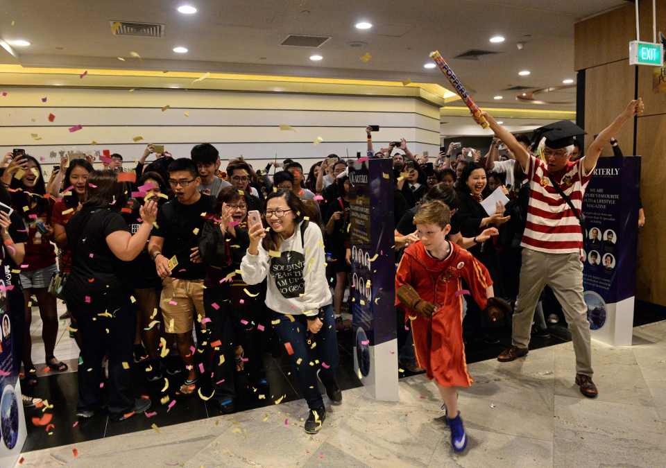 Fans rush as a book store opens its door