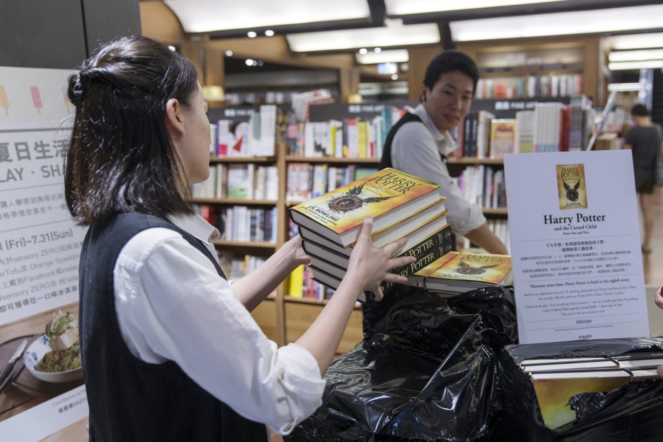 Fans rush as a book store opens its door