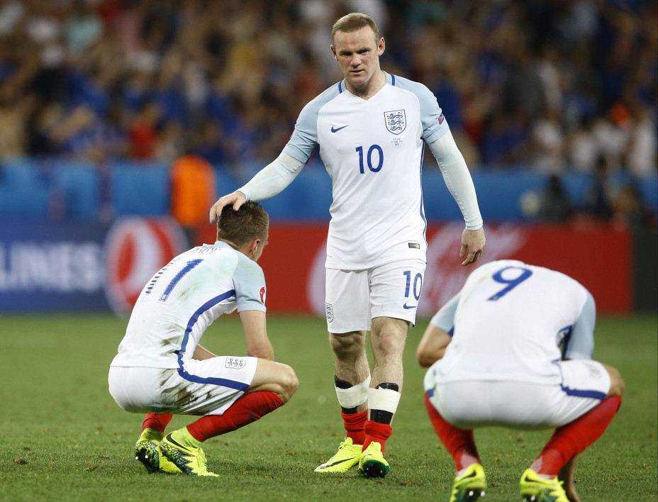 England's Wayne Rooney comforts his teammates at the end of the during the Euro 2016 round of 16 soccer match between England and Iceland, at the Allianz Riviera stadium in Nice, France, Monday, June 27, 2016. (AP Photo/Kirsty Wigglesworth)