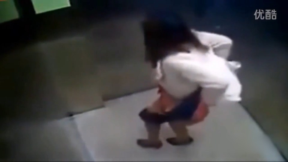  The shameless woman is seen struggling to keep her bowels in check while in the lift